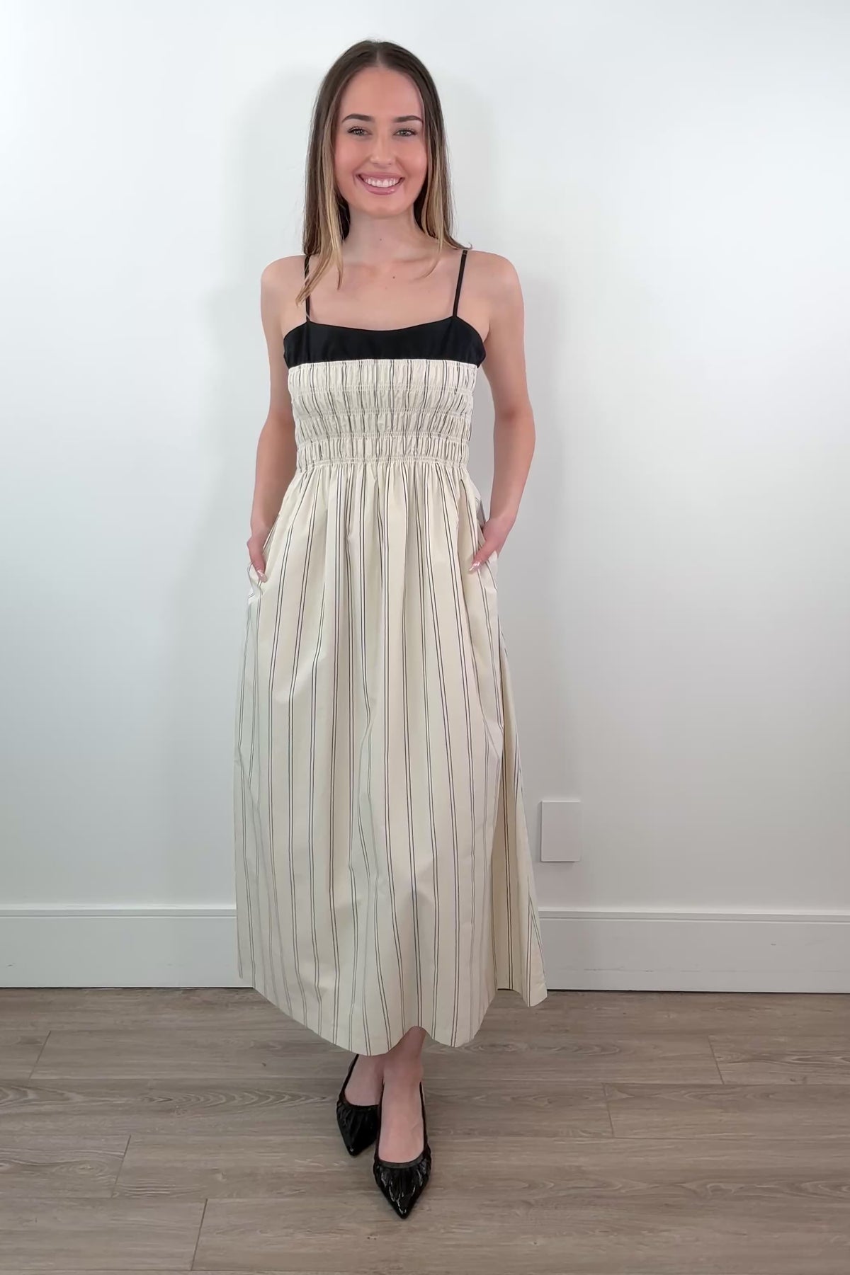 Video of Woman wearing a layered striped dress in cream and black