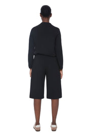 Women wearing long black wide-leg shorts 