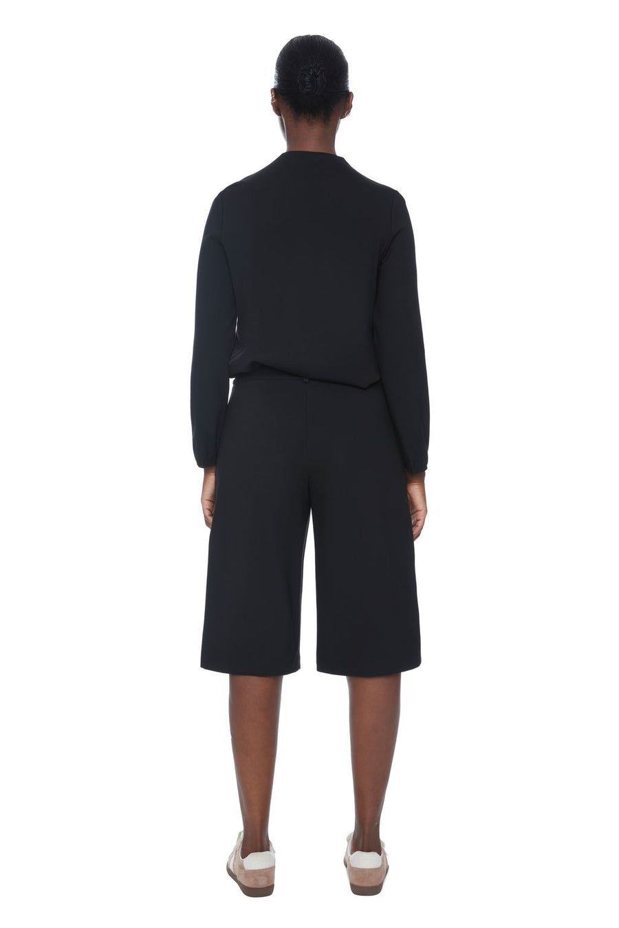 Women wearing long black wide-leg shorts 