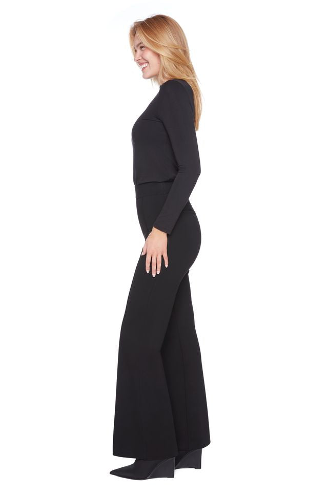 Woman wearing a black long-sleeve dress on a white background