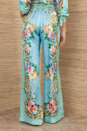 woman wearing a turquoise floral patterned drawstring pants