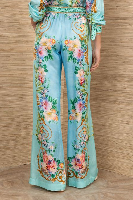woman wearing a turquoise floral patterned drawstring pants
