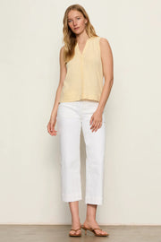 Woman wearing white high-waisted cropped straight-leg pants, front