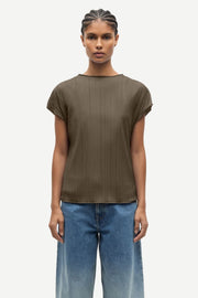 Woman wearing an olive green pleated short-sleeve top with a relaxed fit, front
