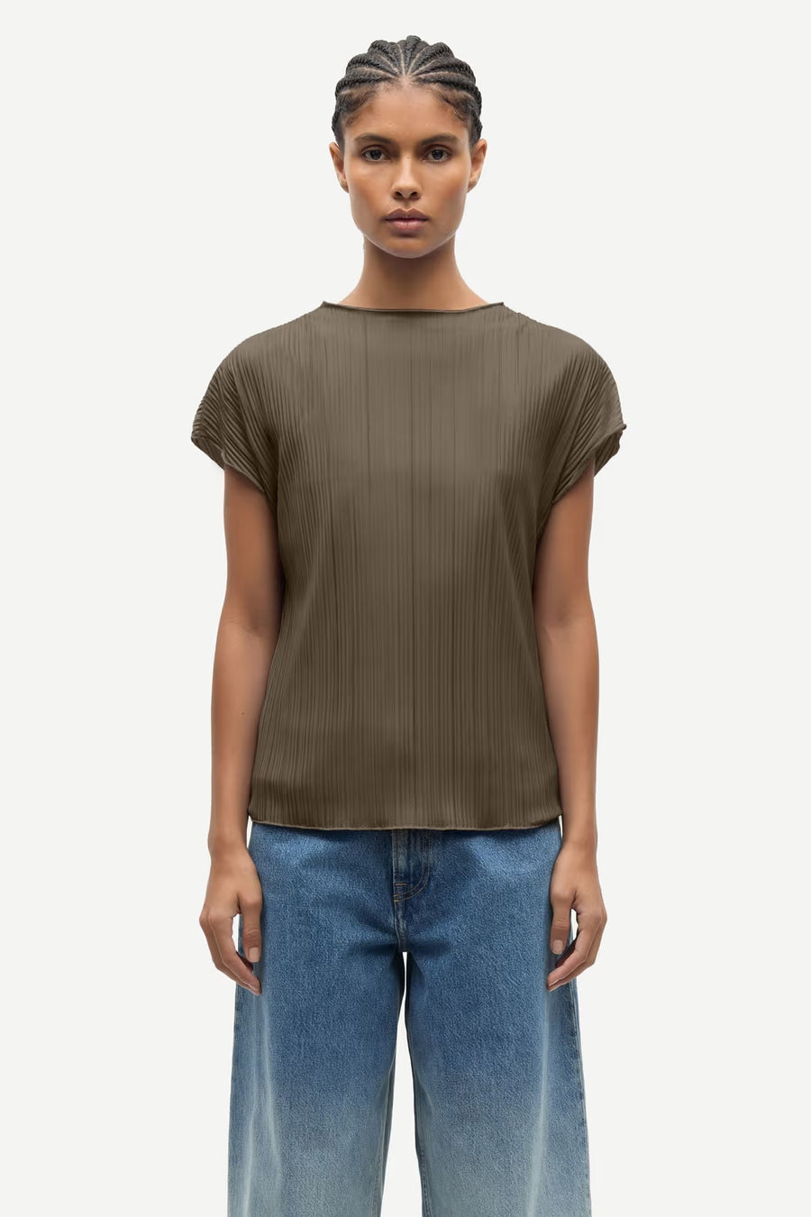 Woman wearing an olive green pleated short-sleeve top with a relaxed fit, front
