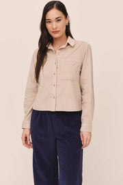 Woman wearing beige button up collard shirt 
