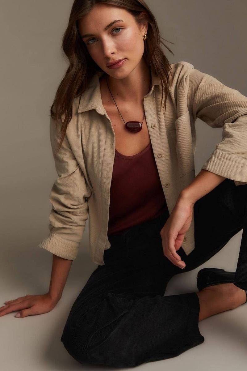 Woman wearing beige button up collard shirt 