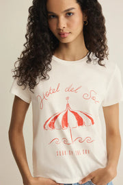 Woman wearing a white short-sleeve graphic T-shirt with red print, detail