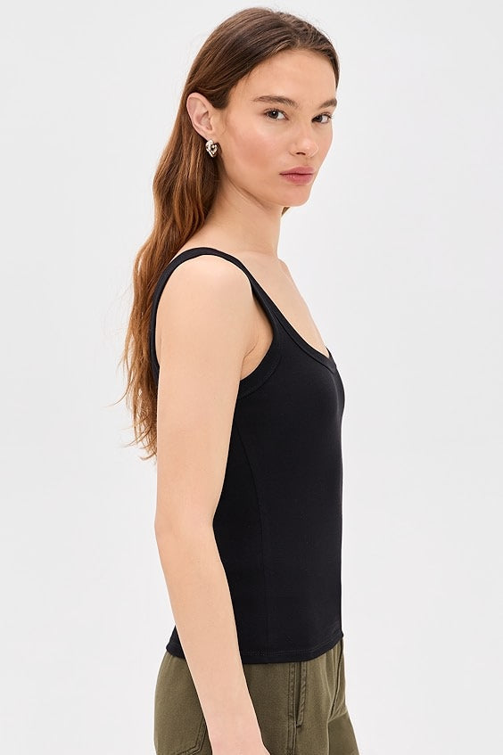 Woman wearing a black tank top with square neckline 