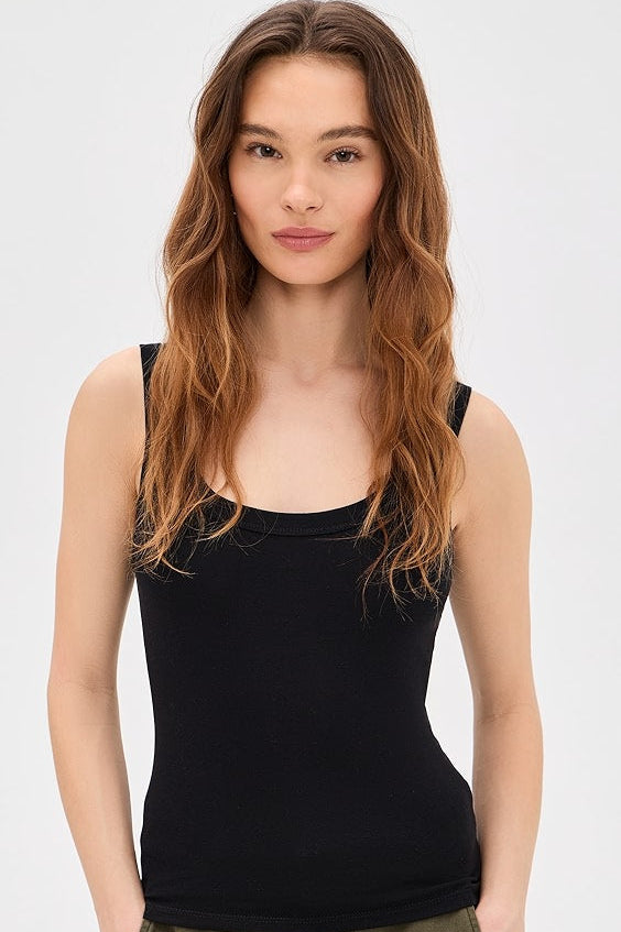 Woman wearing a black tank top with square neckline 