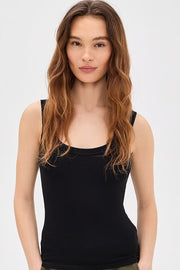 Woman wearing a black tank top with square neckline 