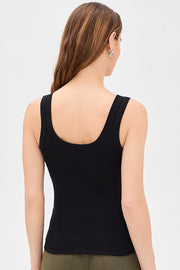 Woman wearing a black tank top with square neckline 