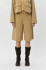 Woman wearing tan high-waisted wide-leg shorts, front