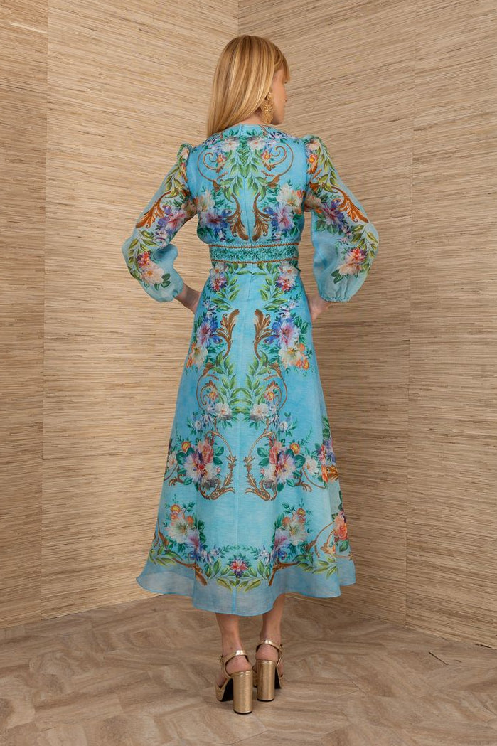 woman wearing a turquoise chiffon floral midi dress