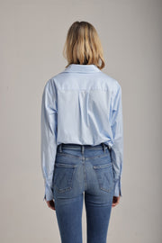 back view of woman wearing a blue collared shirt
