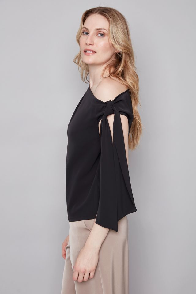 Side view of woman wearing a wide neckline off The shoulder top in black