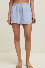 Woman wearing light blue linen short with vertical white stripes and a drawstring, front view