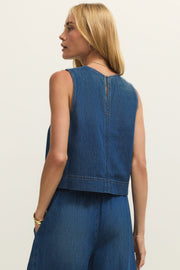 Woman wearing a denim tank top in a dark blue wash, back view