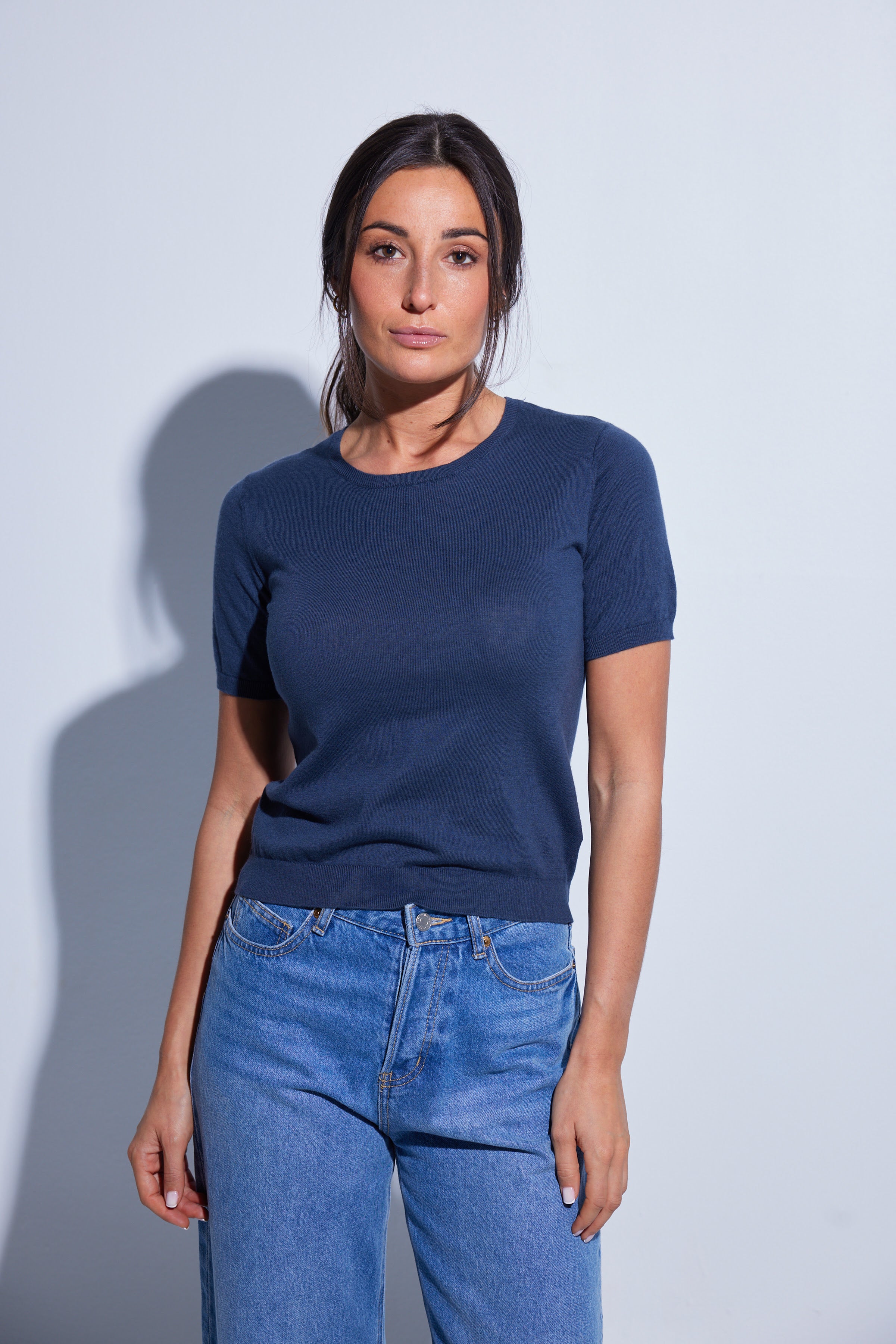 Woman wearing a navy blue t-shirt. 