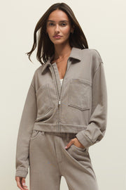 Woman wearing a taupe zip-front jacket with chest pockets, front view