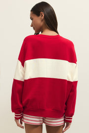 Woman wearing wearing a red and off white color block crewneck sweatshirt with the word "LOVE" written in chenille, back view