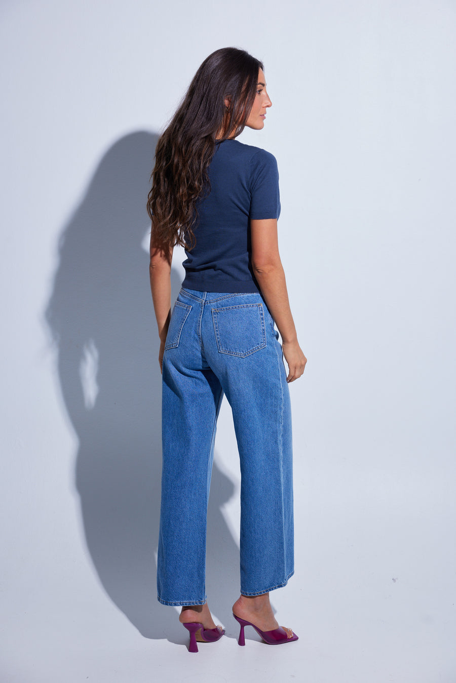 Woman wearing a navy blue t-shirt. 