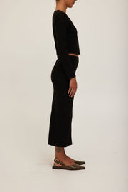 women wearing a midi knit black skirt
