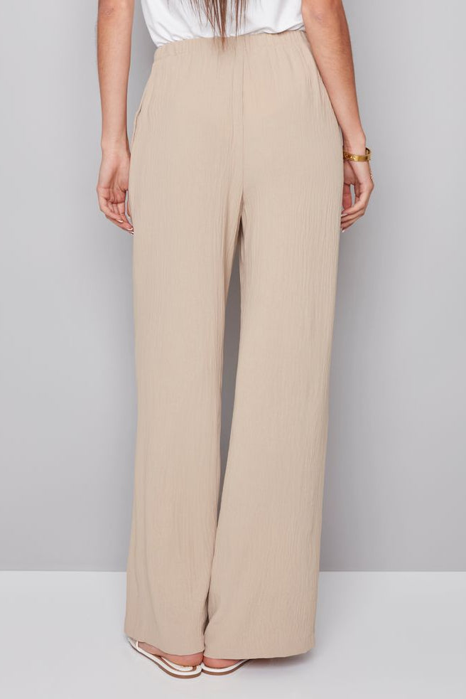 woman wearing a beige drawstring pant