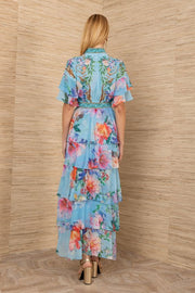 woman wearing a colorful blue tiered floral dress 