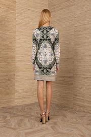 woman wearing an ivory, green and black short long sleeve dress